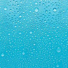 Water droplets in front of a blue background.