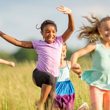 Children running through a field.