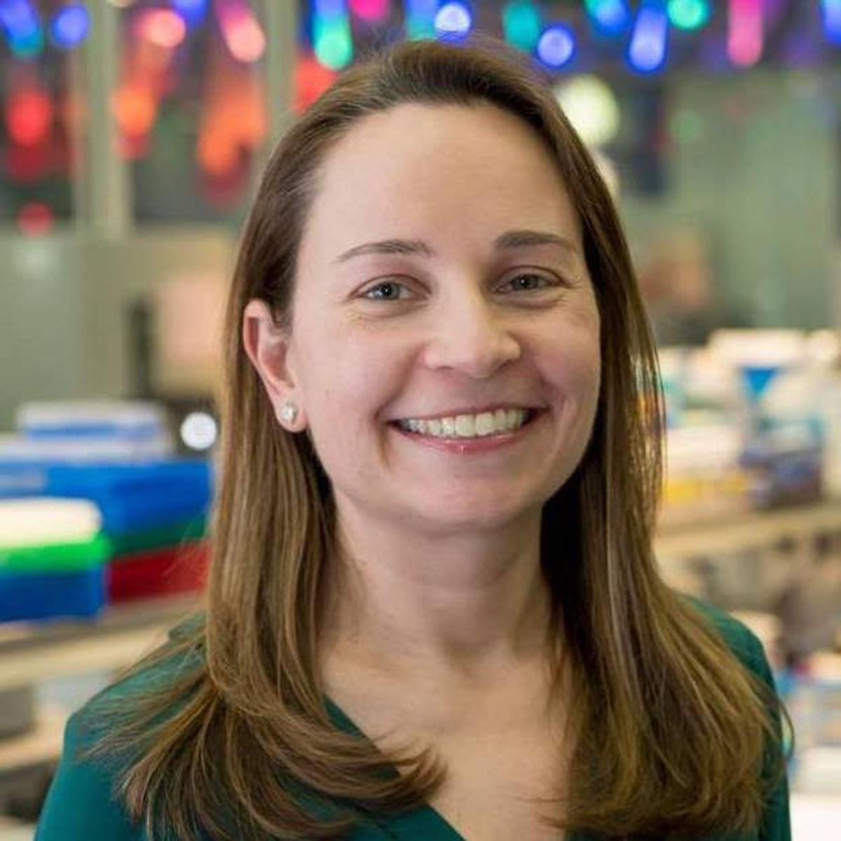 Julie Horvath smiles against a background of laboratory equipment. Julie Horvath smiles against a background of laboratory equipment.