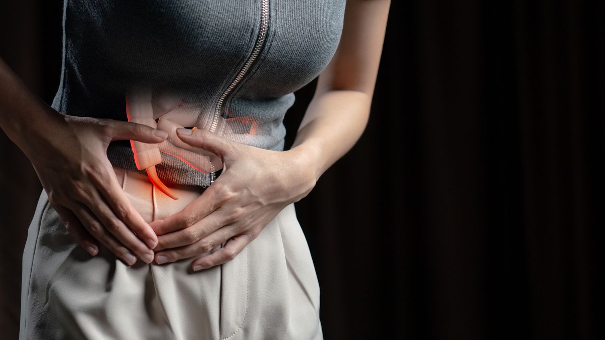 A woman experiencing stomach pain, potentially related to appendicitis. A woman experiencing stomach pain, potentially related to appendicitis.