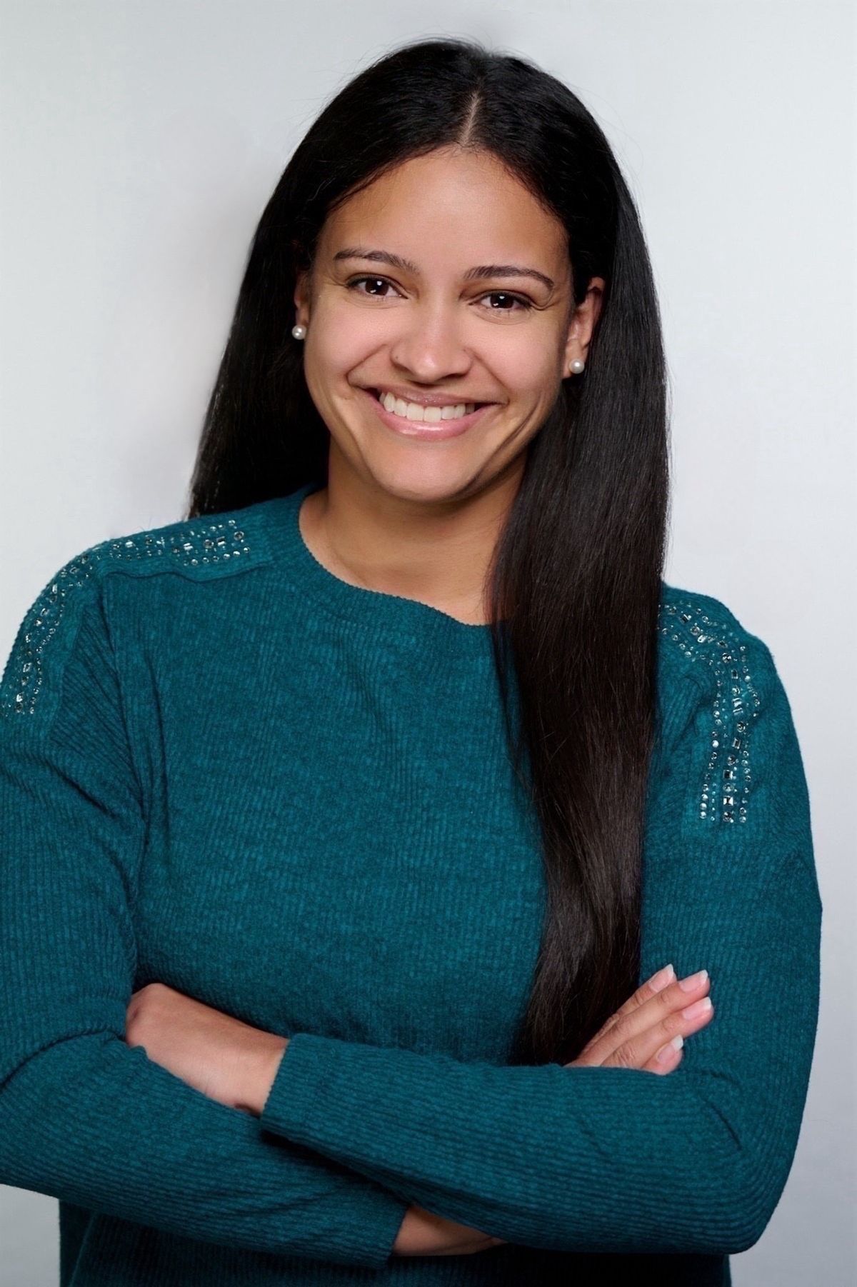 A photograph of Nathalie Fuentes. She has dark hair and is wearing a long-sleeved turquoise shirt, smiling at the camera. A photograph of Nathalie Fuentes. She has dark hair and is wearing a long-sleeved turquoise shirt, smiling at the camera.