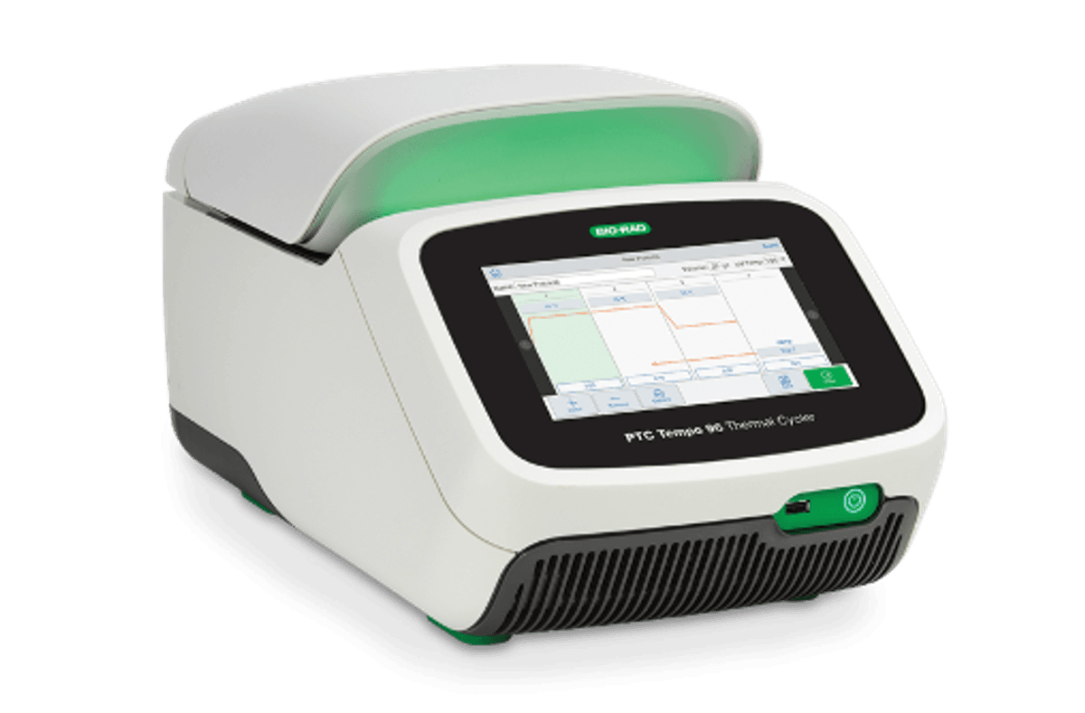 Image of a laboratory PCR instrument in white, green, and black. Image of a laboratory PCR instrument in white, green, and black.